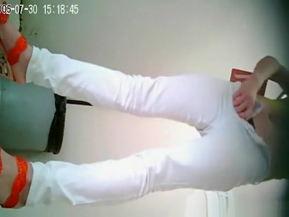 Asian woman in white pants pissing